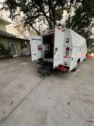 Magnet Plumbing service vehicle on-site for Grease Trap Cleaning in Austin
